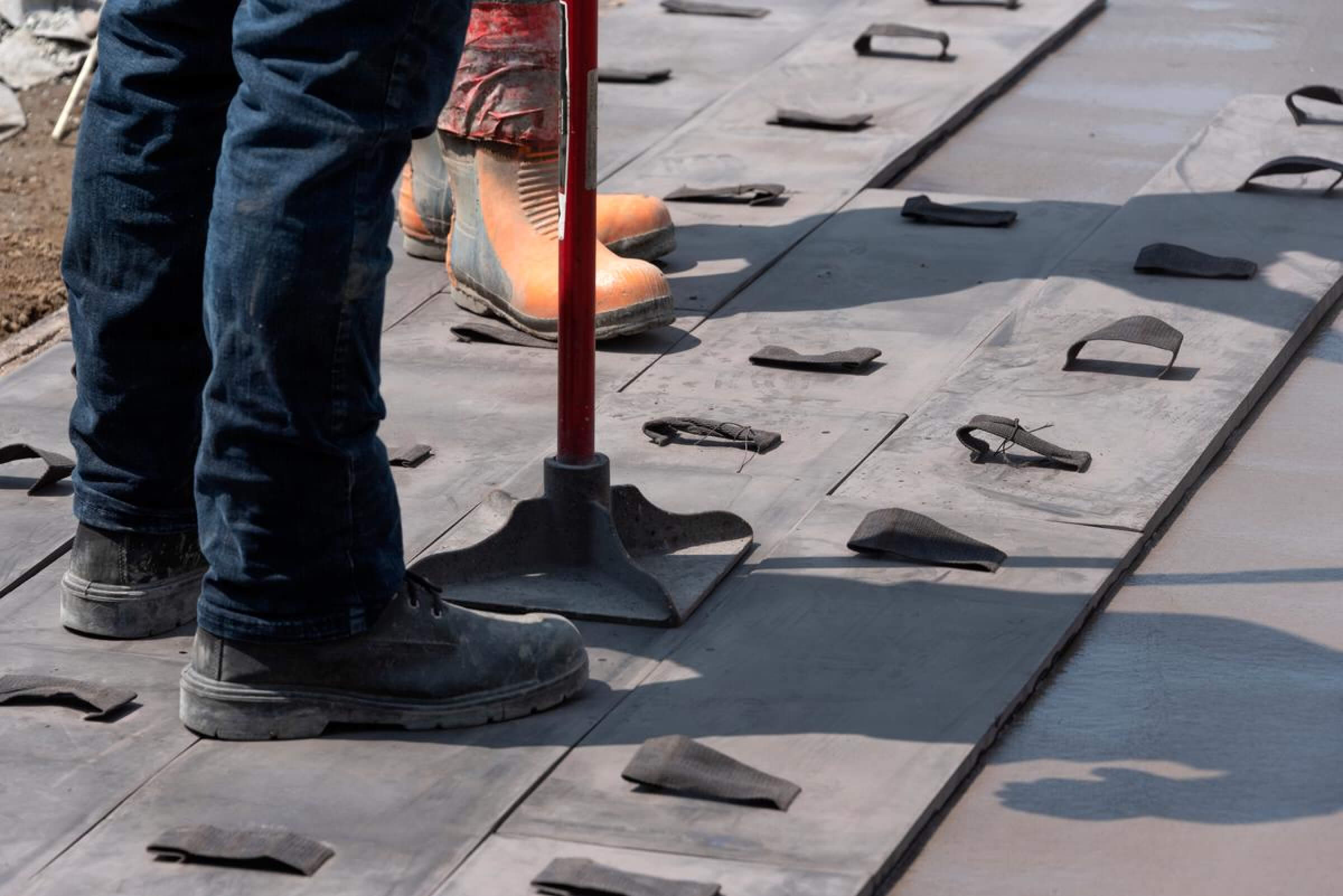 Concrete workers stamping concrete.